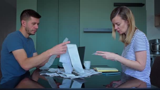 Man and woman looking at payment bills in the kitchen — Stock Video