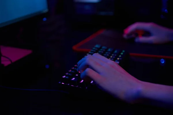 Gamer play computer game, use rgb neon colored keyboard — Stock Photo, Image