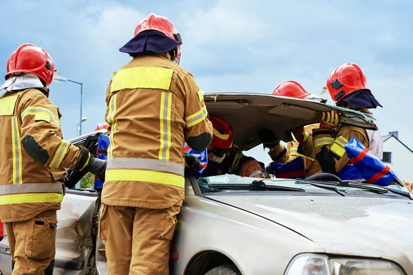 Firefighters during a rescue operation training. Rescuers unlock the passenger in car after accident. Katy Wroclawskie, Poland - May 28, 2022