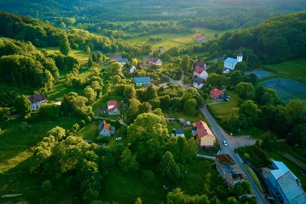 Overhead view of beautiful landscape at sunset, Aerial view of countryside area with village and green fields near mountains