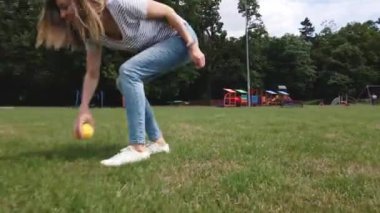 Owner playing with dog at green field, Woman and pet with toy ball have fun together outdoors
