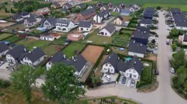 Aerial view of modern suburban neighborhood in small european town, Residential district with private houses in village