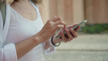 Female tourist use smartphone for navigation in city, Woman in travel walking at city street and use application in phone for looking right direction