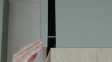 Female hand open kitchen cabinet, Cupboard door in kitchen furniture