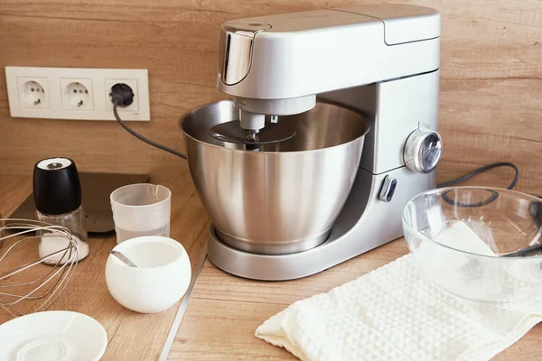 Silver food processor in kitchen interior, kitchen electric mixer on table, Modern kitchen appliance for cooking