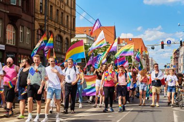 People crowd have fun at gay pride parade with rainbow flags, March on city street in support of LGBT community. Wroclaw, Poland - June 11, 2022