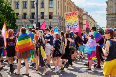 People crowd have fun at gay pride parade with rainbow flags, March on city street in support of LGBT community. Wroclaw, Poland - June 11, 2022