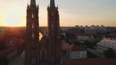 Drone flight over Tumski island and Cathedral of St John the Baptist in Wroclaw at morning sunrise light, Aerial view of old town with historical architecture in Wroclaw city, Poland