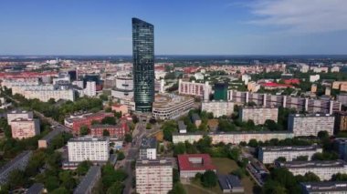 Drone flight over Wroclaw cityscape with Sky Tower skyscraper. Aerial view of modern european city in Poland