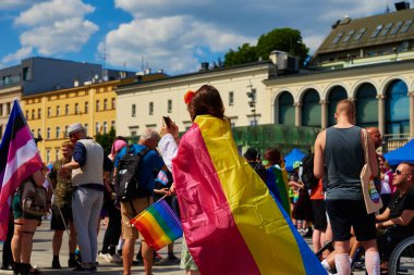 People crowd have fun at gay pride parade with rainbow flags, March on city street in support of LGBT community. Wroclaw, Poland - June 11, 2022