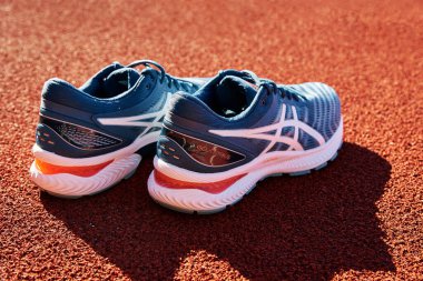 Asics Gel Nimbus running shoes at stadium track, Pair of Asics sport sneakers for jogging. Katy Wroclawskie, Poland - August 07, 2022