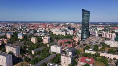 Drone flight over Wroclaw cityscape with Sky Tower skyscraper. Aerial view of modern european city in Poland