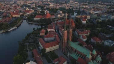 Drone flight over Tumski island and Cathedral of St John the Baptist in Wroclaw at morning sunrise light, Aerial view of old town with historical architecture in Wroclaw city, Poland