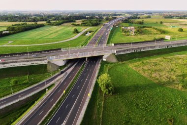 Aerial view of cars driving on round intersection in city, Transportation roundabout infrastructure, Highway road junction in Wroclaw, Poland
