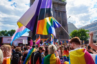 People crowd have fun at gay pride parade with rainbow flags, March on city street in support of LGBT community. Wroclaw, Poland - June 11, 2022