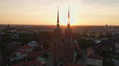 Drone flight over Tumski island and Cathedral of St John the Baptist in Wroclaw at morning sunrise light, Aerial view of old town with historical architecture in Wroclaw city, Poland
