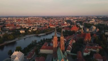 Drone flight over Tumski island and Cathedral of St John the Baptist in Wroclaw at morning sunrise light, Aerial view of old town with historical architecture in Wroclaw city, Poland