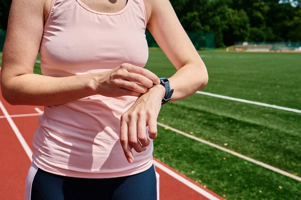 Woman use fitness watch before cardio exercises, Checking results on smart watch after training, Healthy lifestyle concept