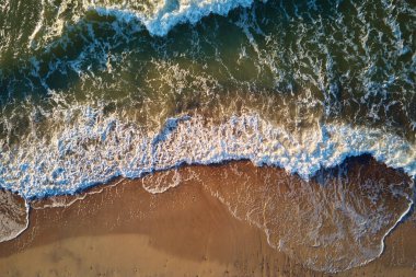 Sand beach with sea waves, top view. Summer vacation and travel concept. Beautiful coastline with baltic sea and sand beach, aerial view