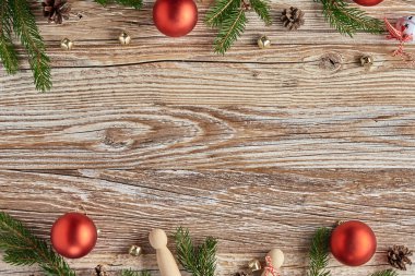Christmas composition with fir tree branches and lighting garland on wooden background. Christmas frame, flat lay. Xmas greeting banner with copy space