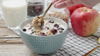 Granola with milk in blue bowl on wooden table, Healthy organic breakfast with muesli, Food clean eating concept