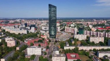 Drone flight over Wroclaw cityscape with Sky Tower skyscraper. Aerial view of modern european city in Poland