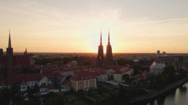Drone flight over Tumski island and Cathedral of St John the Baptist in Wroclaw at morning sunrise light, Aerial view of old town with historical architecture in Wroclaw city, Poland