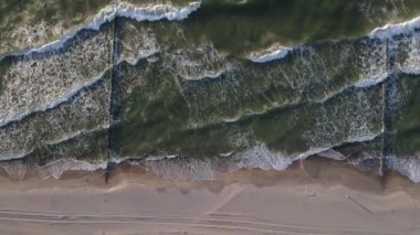 Sand beach with sea waves, top view. Summer vacation and travel concept. Beautiful coastline with baltic sea and sand beach, aerial view