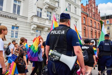 Police guarding demonstrators with rainbow flags for supporting LGBT community. Wroclaw, Poland - June 11, 2022
