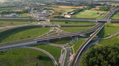 Aerial view of cars driving on round intersection in city, Transportation roundabout infrastructure, Highway road junction in Wroclaw, Poland