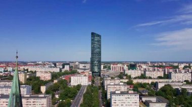 Drone flight over Wroclaw cityscape with Sky Tower skyscraper. Aerial view of modern european city in Poland