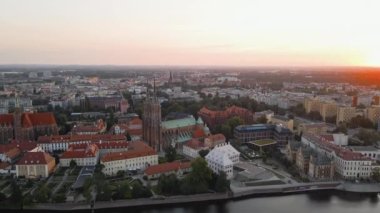 Drone flight over Tumski island and Cathedral of St John the Baptist in Wroclaw at morning sunrise light, Aerial view of old town with historical architecture in Wroclaw city, Poland