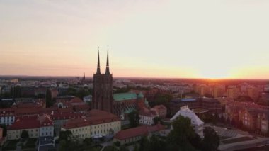 Drone flight over Tumski island and Cathedral of St John the Baptist in Wroclaw at morning sunrise light, Aerial view of old town with historical architecture in Wroclaw city, Poland