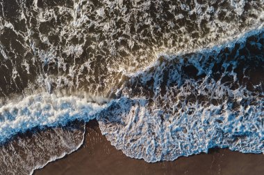 Sand beach with sea waves, top view. Summer vacation and travel concept. Beautiful coastline with baltic sea and sand beach, aerial view