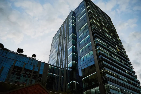 Administrative center in Warsaw, Business office building in downtown central district, Skyscraper with glass facade against blue sky