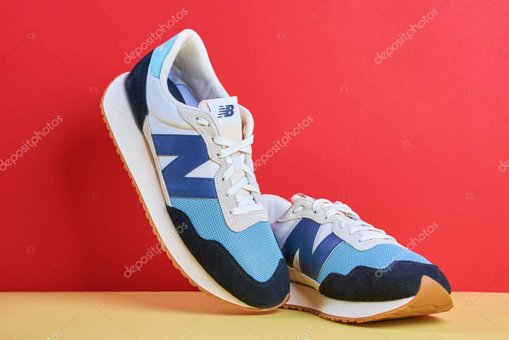 Pair of trendy New Balance shoes model MS237HL1 on creative colorful background. Stylish fashionable minimalism concept. Wroclaw, Poland - May 08, 2022
