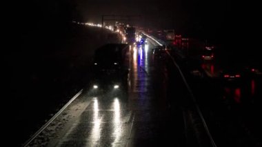 Car accident on slippery road at night during snowfall, Dangerous driving during winter snowstorm