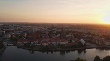Drone flight over Tumski island and Cathedral of St John the Baptist in Wroclaw at morning sunrise light, Aerial view of old town with historical architecture in Wroclaw city, Poland