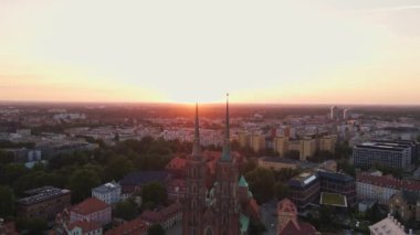 Drone flight over Tumski island and Cathedral of St John the Baptist in Wroclaw at morning sunrise light, Aerial view of old town with historical architecture in Wroclaw city, Poland