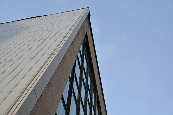 青い雲のない空に対するガラスとコンクリートの幾何学的組成 多くの長方形の窓のあるモダンな建物 選択的焦点 — ストック写真