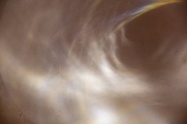 Kahverengi bir duvarda çeşitli soyut şekillerdeki güneş ışınları. Alçılı bir duvarda farklı çizgiler ve ışık noktaları. Farklı tasarım görevleri için soyut çoklu görev geçmişi. Seçici odak.