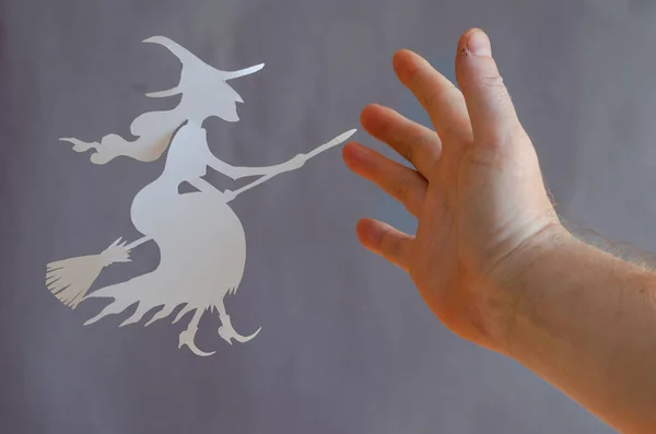 Man Stops Flying Witch Broomstick His Hand White Paper Witch — Stock Photo, Image