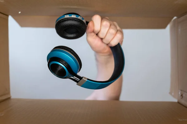 Man Hand Pulls Headphones Out Cardboard Moving Box Wireless Stereophonic — Photo