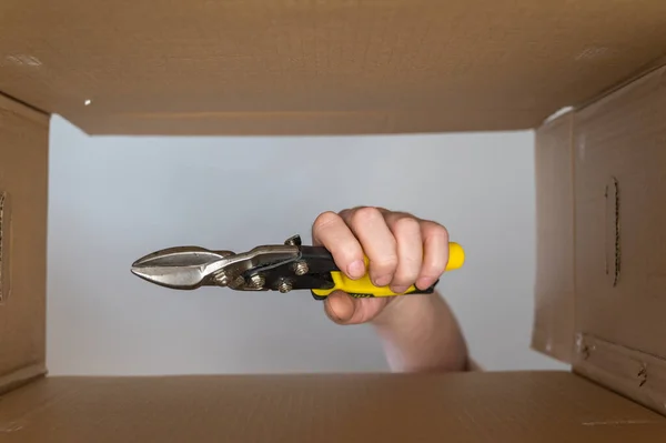 Man Hand Puts Sheet Metal Cutter Cardboard Moving Box Hand — Foto de Stock