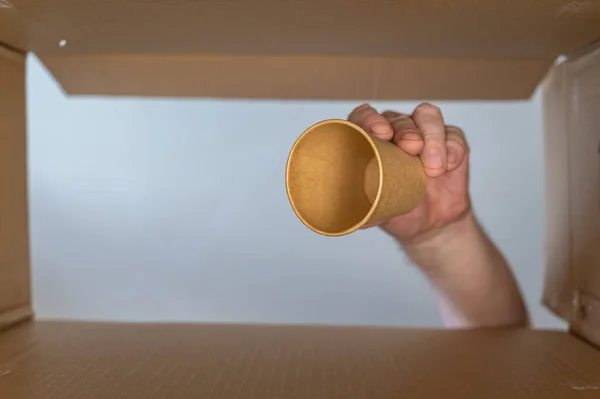 Man Hand Puts Paper Cup Cardboard Moving Box Disposable Drink — Photo