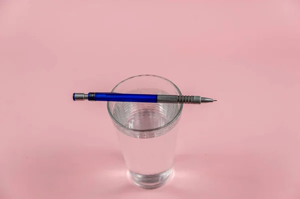 Glass Water Pencil Pink Background Full Glass Drinking Water Blue — Stock fotografie