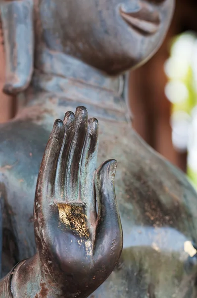 Spiritual concept with standing bronze Buddha statue with open gold palm. — Stock Photo, Image