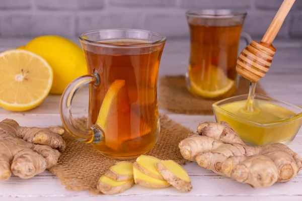 Tea with ginger and lemon in transparent cups.