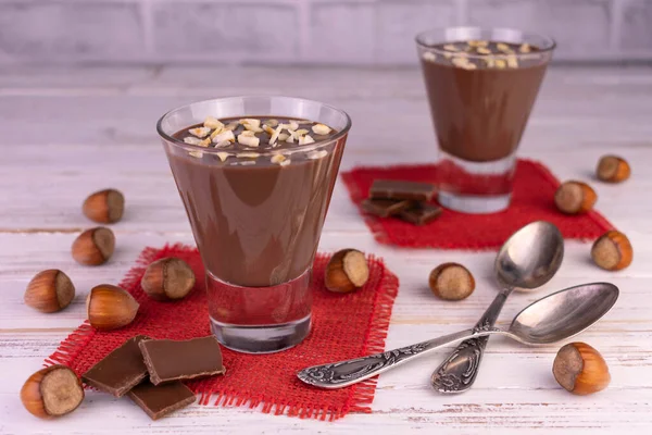 Beyaz ahşap arka planda fındıklı çikolatalı mus..