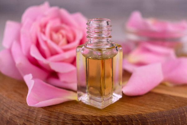 Bottle of rose essential oil. Close-up.